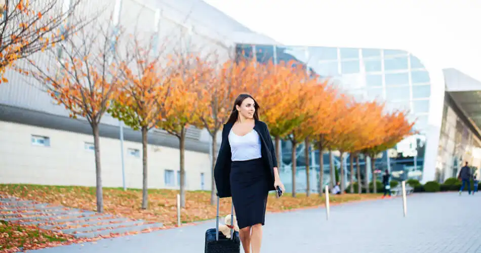 Caucasian businesswoman walking with a suitcase