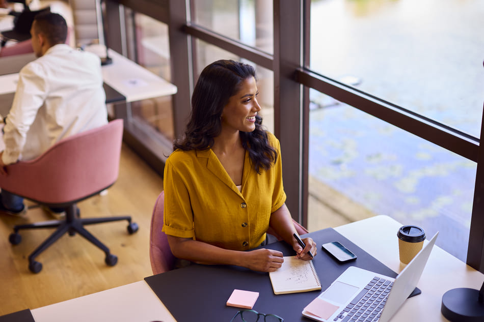 Brasilian businesswomean working on her laptop in a shared office