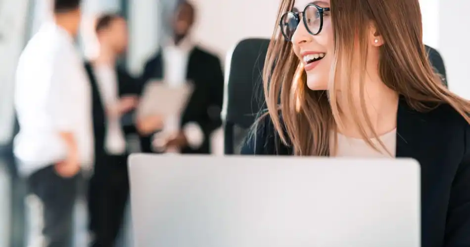 Cheerful office worker at her laptop