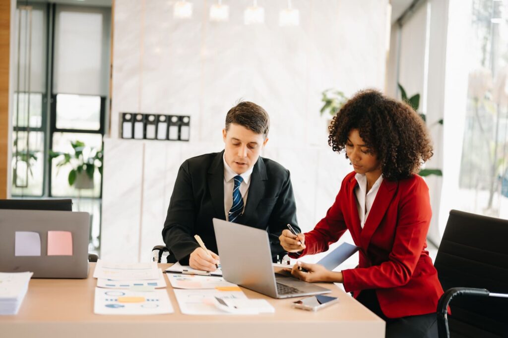 Portrait of female and male colleague working together