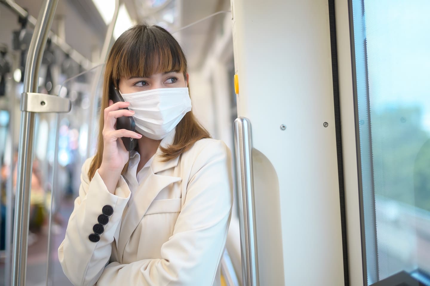 Young woman wearing mask while travelling