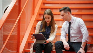 Female covworker leading a meeting with male coworker