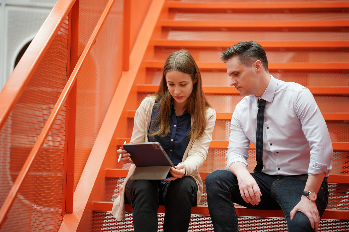 Female covworker leading a meeting with male coworker