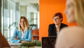 Three female colleagues in a meeting discussing strategy