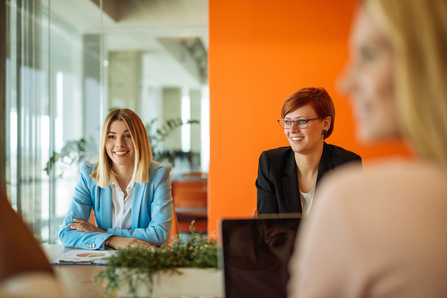 Three female colleagues in a meeting discussing strategy