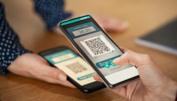 Woman scanning QR Code for mobile payment